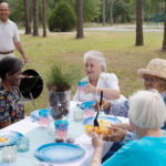 Residents enjoying a meal outdoors.